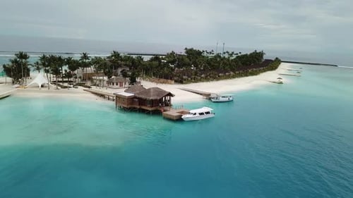 Drone FPV shot, Maldives island port, tropical jungle in the middle of the ocean. 4K