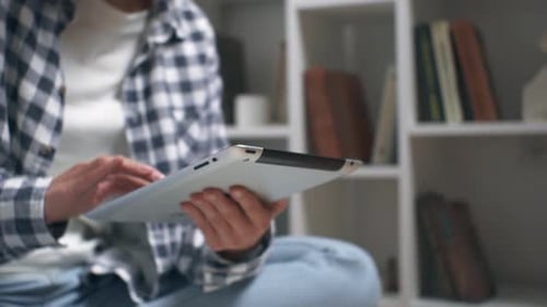 Person Using Tablet in Home Setting