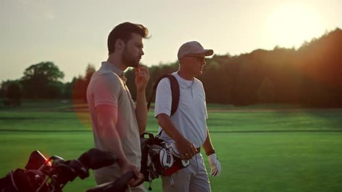 Rich Men Playing Golf on Sunset Summer Course