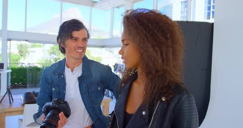 Photographer and Model Collaborating in Bright Studio