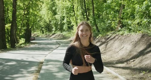 Young Woman Runner Training in Summer Park. Close Up of Fitness Woman Running at Morning Outdoors
