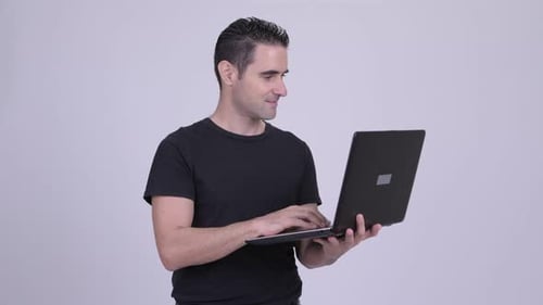Man Types on Laptop Computer