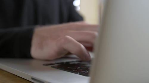 Hands Typing on Laptop Keyboard Close Up