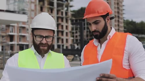 Architects Reviewing Plans at a Construction Site