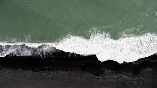 Top down View of Waves Crashing on the Black Sand Beach of Reynisfjara in Iceland