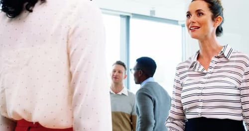 Executives shaking hands in office