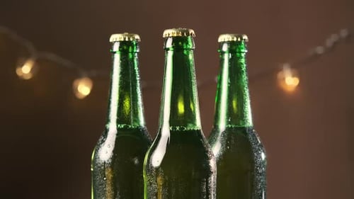 Three Green Bottles with Golden Caps