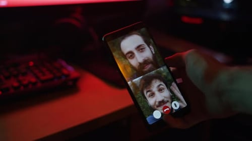 Man Video Chatting on Phone in Dark Room