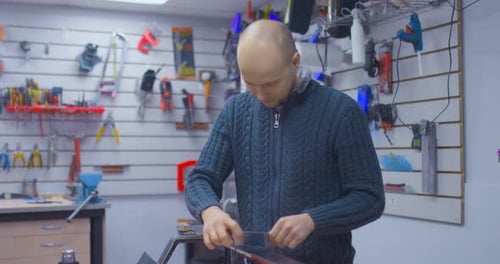 Male Master Scraper Removes Excess Wax From the Ski