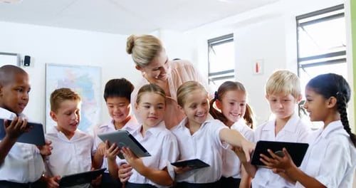 Teacher and Students Use Tablets in Classroom