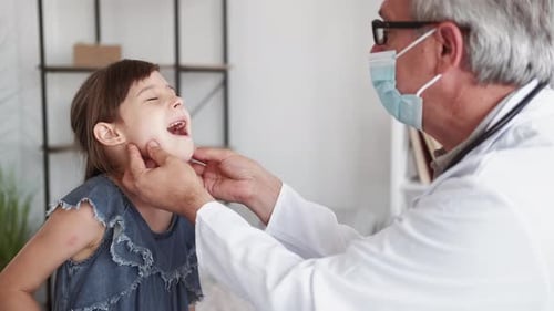 Doctor Examines Young Girl in Modern Clinic