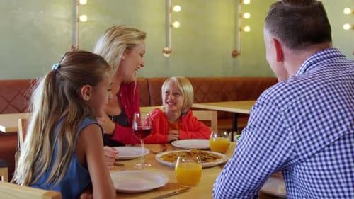 Family Enjoys Meal Together in Urban Restaurant