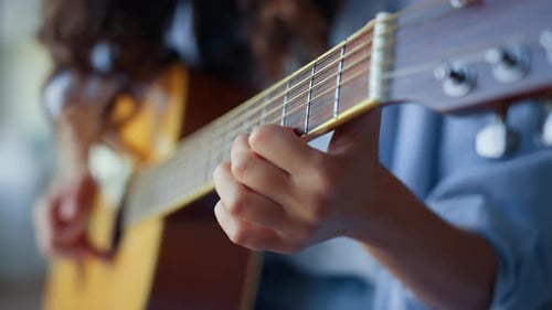 Close Up of Guitar Playing at Home
