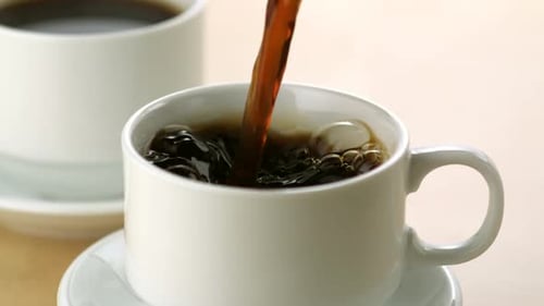 Coffee Pouring into a Mug in Close Up