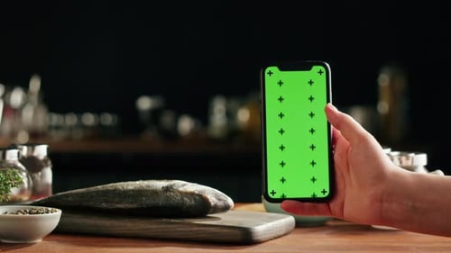 Cooking Fish Woman Using Smartpgone with Chroma Key Green Screen