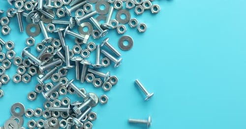 Shiny Hardware Parts on a Blue Surface