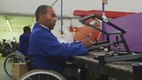 Adults Working with Metal in Factory Setting