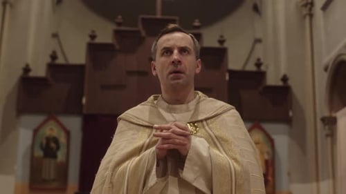Priest Walking along Catholic Church