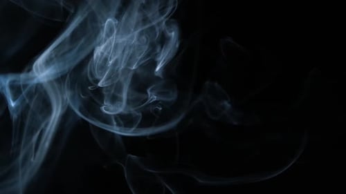 Abstract Wisps of Smoke Drifting on Black Background