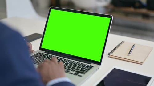 Businessman Using Laptop with Green Chroma Key Screen
