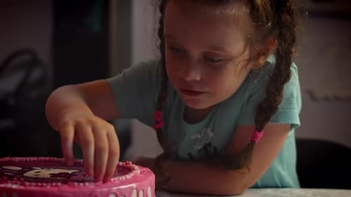 Girl Decorating Birthday Cake with Sprinkles