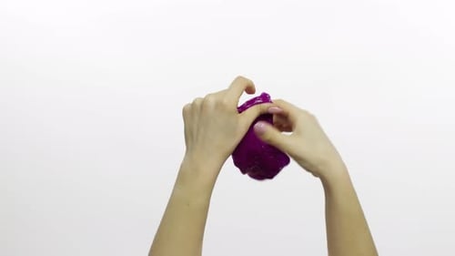 Woman Hands Playing Oddly Satisfying Purple Slime. White Background. Antistress