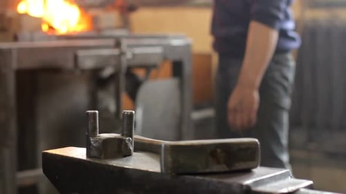 Blacksmith Anvil, Hammer, and Metalwork in Workshop