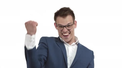 Successful Happy Businessman in Blue Suit and Glasses Rejoicing Shouting for Joy and Victory Saying
