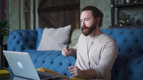 Adult Man Talking to Laptop at Home