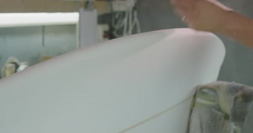 Male surfboard maker in his workshop