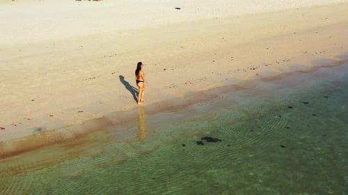Modern happy ladies relaxing spending quality time at the beach on sunny blue and white sand backgro