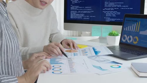 Business Team Analyzes Data with Graphs and Charts