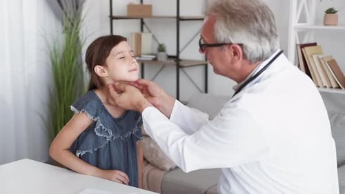 Doctor Examining Child Patient in Clinic