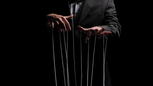 Puppenspieler zieht die Puppenfäden, die an seine Finger gebunden sind