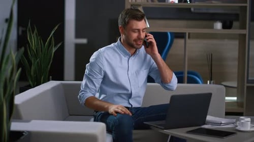 Excited Man Working from Home on Laptop