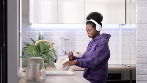 Woman mixing ingredients at kitchen counter
