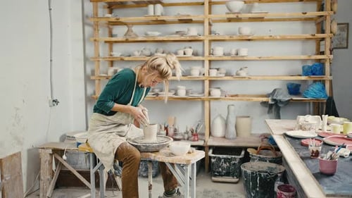 Female Potter Creating Ceramic Vase at Studio Working on Pottery Wheel Tracking Shot Slow Motion