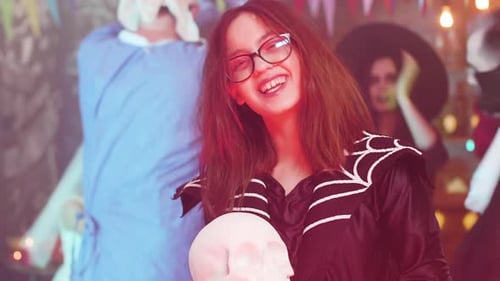 Girl in Enchantress Costume Hold a Skull and Laughs Evil