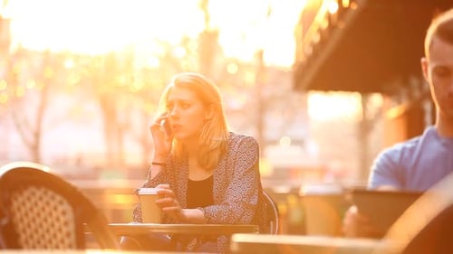 Cafe in London with man and woman drinking their coffees