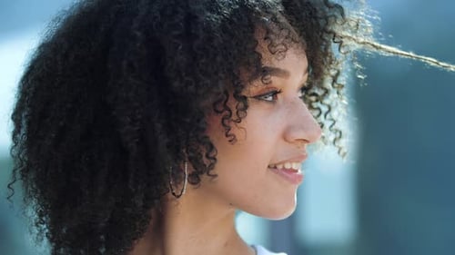Face Portrait of Cute Positive Pretty African Young Brunette Woman Model with Long Curly Hairstyle