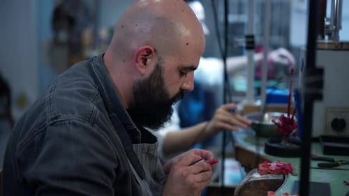 Side View Concentrated Professional Bearded Bald Jeweller Working in Slow Motion in Workshop with