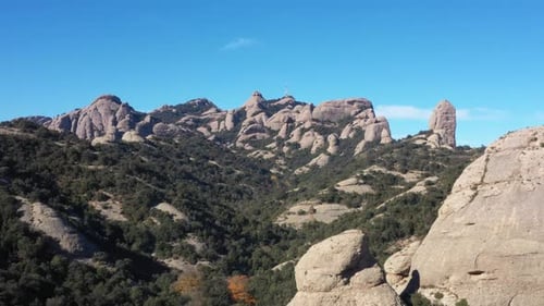 Descending aerial shot of scenic mountain range in Montserrat , Spain