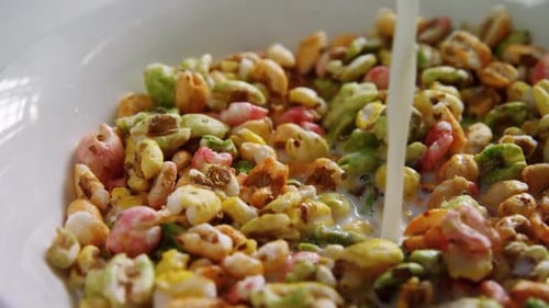 Pouring Milk on Colorful Cereal in Bowl