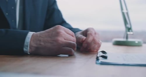 Close up of male hands holding pen and showing how to fill in form