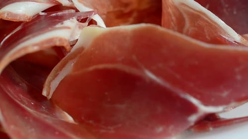Jamon on the plate. Shooting in motion.