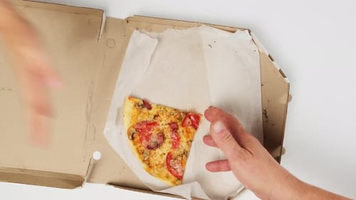 Hand Grabbing Pizza Slice from Pizza Box
