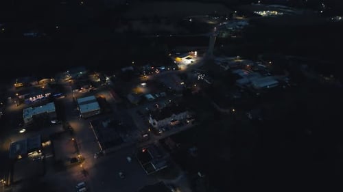 Drone Flying Over Small Town at Night