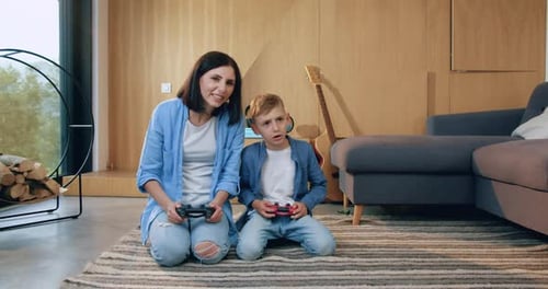 Woman and Boy Playing Video Games at Home