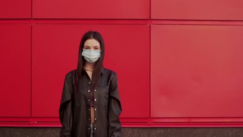 Woman Wearing Mask Holding Stop Covid Sign