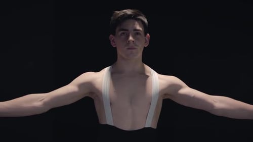 Professional Caucasian Male Ballet Dancer Spinning and Smiling in Darkness. Handsome Confident Man